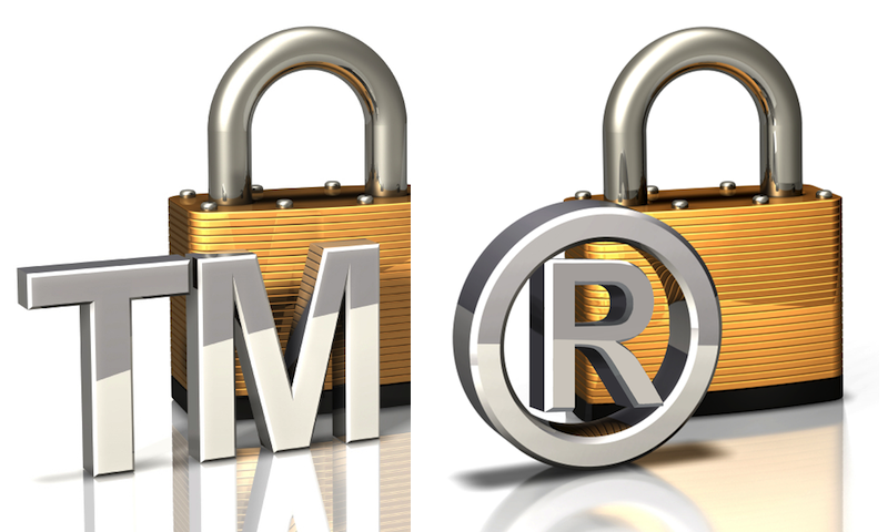 Gold and silver padlock with "TM" trademark common-law symbol followed by thicker padlock with "circled R" registered trademark symbol